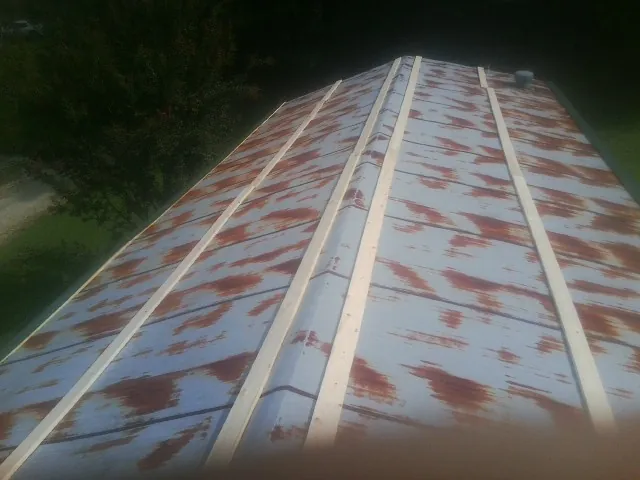 Rusted metal roof panels with new wood purlins before replacement — Storm Damage Roof Repair in Mandeville by Roofing Brothers